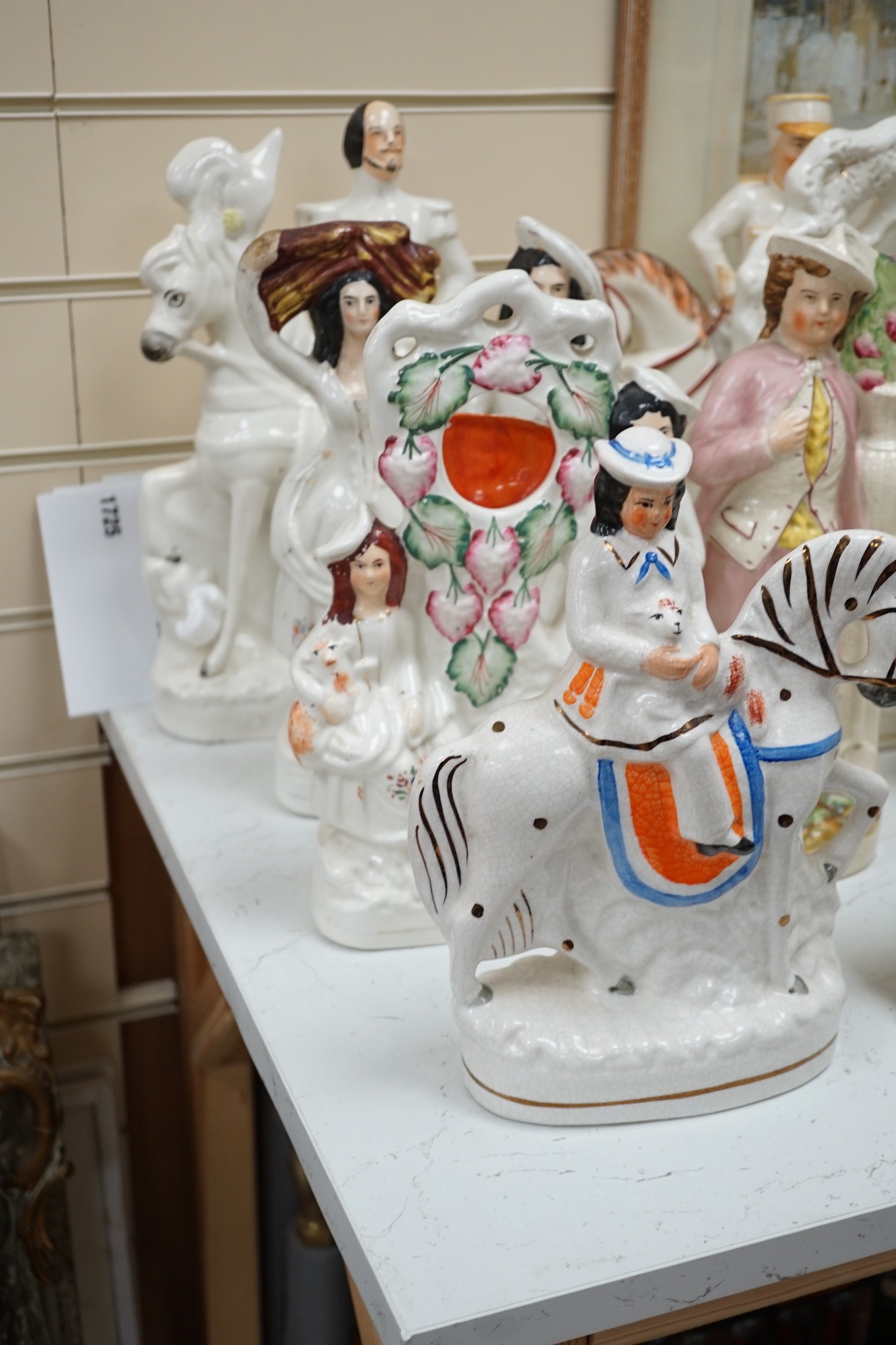 A collection of Victorian Staffordshire pottery flat-back figures and groups, tallest 36cm